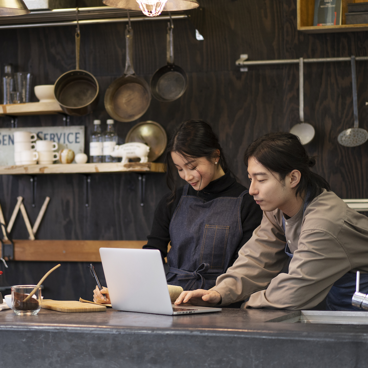 japanese-man-woman-working-using-laptop-restaurant